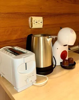 a kitchen counter with a toaster and a coffee pot at Еmerald Apartment Complex in Bansko