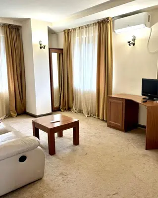 a living room with a couch and a table at Еmerald Apartment Complex in Bansko
