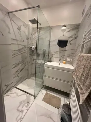 a bathroom with a shower and a sink at Lux, Spacious and Comfort Apartment next to National Palace of Culture in Sofia