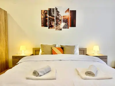 a bedroom with a white bed with towels on it at Top Centre 2BDR Apartment for 4 Guests next to Theater Tear and Laughter in Sofia