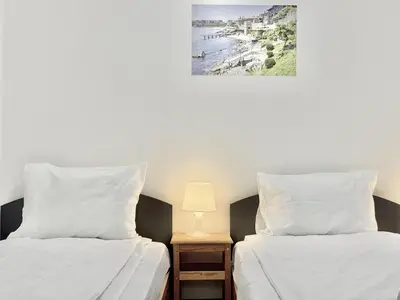 two beds sitting next to each other in a bedroom at Top Centre 2BDR Apartment for 4 Guests next to Theater Tear and Laughter in Sofia