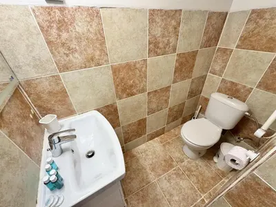 a bathroom with a toilet and a sink at Top Centre 2BDR Apartment for 4 Guests next to Theater Tear and Laughter in Sofia