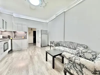 a living room with a couch and a table at Top City Centre 1BDR Apartment next to Theater Tear and Laughter in Sofia