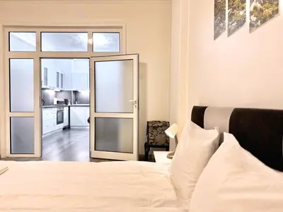 a bedroom with a bed and a sliding glass door at Top City Centre 1BDR Apartment next to Theater Tear and Laughter in Sofia