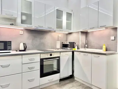 a white kitchen with white cabinets and appliances at Top City Centre 1BDR Apartment next to Theater Tear and Laughter in Sofia