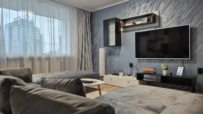 a living room with two couches and a flat screen tv at Spacious 3 BDR City Pulse near Airport, The Mall, Arena 8888 by KeyBox in Sofia