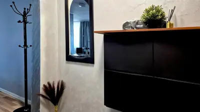 a room with a mirror and a shelf with a plant at Spacious 3 BDR City Pulse near Airport, The Mall, Arena 8888 by KeyBox in Sofia