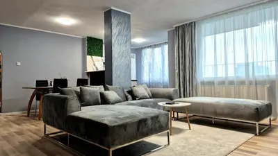 a living room with a couch and a table at Spacious 3 BDR City Pulse near Airport, The Mall, Arena 8888 by KeyBox in Sofia