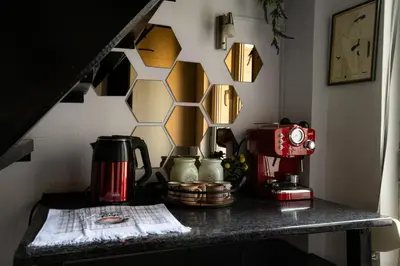 a counter top with a coffee maker and a coffee machine at 1 min from NDK and Vitoshka street in Sofia