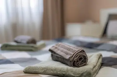 two towels sitting on top of a bed at 1 min from NDK and Vitoshka street in Sofia