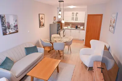 a living room with a couch and a table at 2 Luxurious one bedroom apartments 5 minute walk from the Gondola station in Bansko