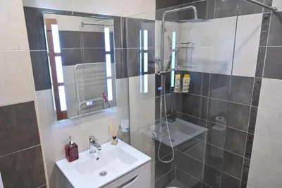a bathroom with a sink and a shower at 2 Luxurious one bedroom apartments 5 minute walk from the Gondola station in Bansko