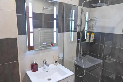 a bathroom with a sink and a shower at 2 Luxurious one bedroom apartments 5 minute walk from the Gondola station in Bansko