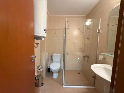 a bathroom with a shower and a toilet and a sink at Bansko Bliss - Peaceful Stay with Balcony Views in Bansko
