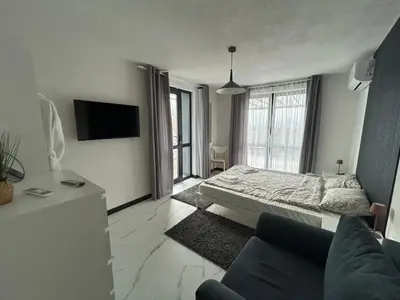 a living room with a bed and a couch at Къща за гости Алино Хаус in Alino