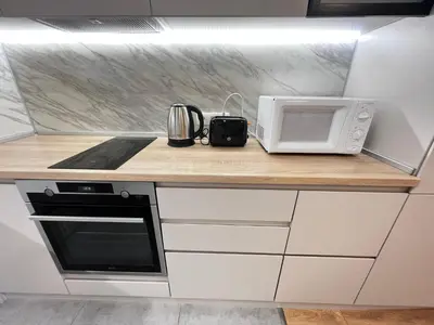 a kitchen counter with a microwave and a toaster oven at Barcelona 2BDR Cozy Apt w Working Space near Metro in Sofia