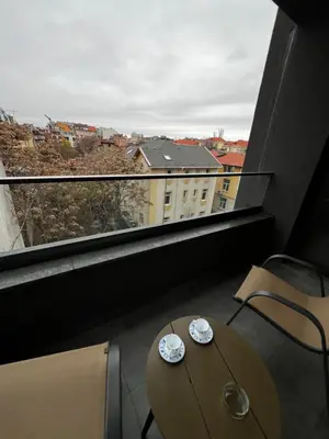 a balcony with a table and chairs and a window at Barcelona 2BDR Cozy Apt w Working Space near Metro in Sofia