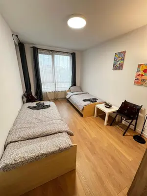 a bedroom with two beds and a window at Barcelona 2BDR Cozy Apt w Working Space near Metro in Sofia