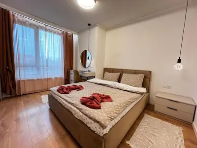 a bedroom with a bed with red towels on it at Barcelona 2BDR Cozy Apt w Working Space near Metro in Sofia