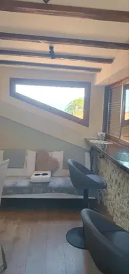 a living room with a couch and a window at Къща за гости ОЗИ 3 in Ovchartsi