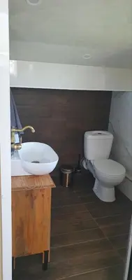 a bathroom with a sink and a toilet at Къща за гости ОЗИ 3 in Ovchartsi