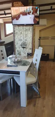 a kitchen with a table and chairs in a room at Къща за гости ОЗИ 3 in Ovchartsi