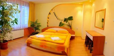 a bedroom with a bed in a room with plants at Royal Apartment in Smolyan