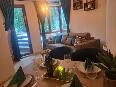 a living room with a table with wine glasses at Alpine Apart Pamporovo in Pamporovo