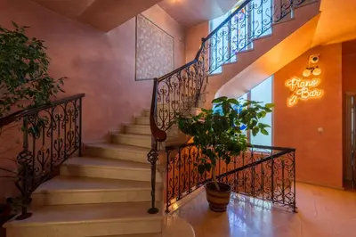 a staircase in a house with a potted plant at Family Hotel Lazur in Kyustendil
