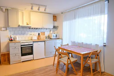 a kitchen with a table and chairs and a table and a table at Comfortable 1-Bedroom Apartments in Bansko - Close to Gondola by Flat Mаnаger in Bansko
