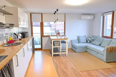 a kitchen and a living room with a blue couch at Comfortable 1-Bedroom Apartments in Bansko - Close to Gondola by Flat Mаnаger in Bansko