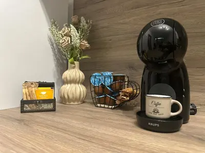 a coffee maker sitting on a table with a cup at Le Bijou МОЛ Плаза in Plovdiv