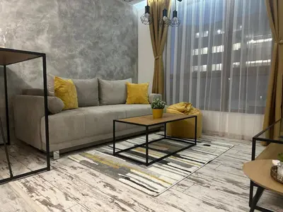 a living room with a couch and a table at Le Bijou МОЛ Плаза in Plovdiv