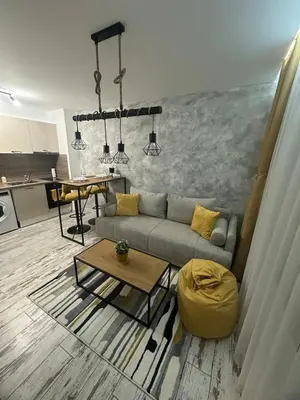 a living room with a couch and a table at Le Bijou МОЛ Плаза in Plovdiv