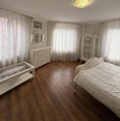 a bedroom with a bed and a dresser and a mirror at Кольовата къща Тетевен in Teteven