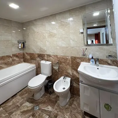 a bathroom with a toilet and a sink and a tub at Кольовата къща Тетевен in Teteven