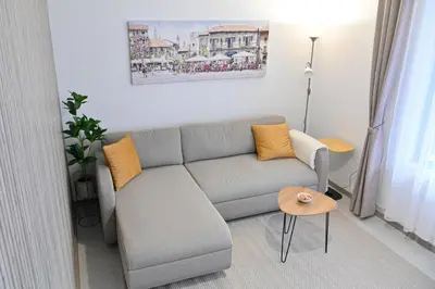 a living room with a couch and a table at White Peaks 1BR Apartment Bansko by SI Stay in Bansko