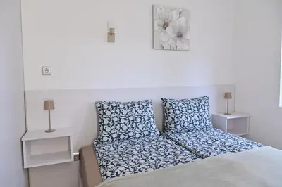 a bedroom with a bed with blue and white pillows at White Peaks 1BR Apartment Bansko by SI Stay in Bansko