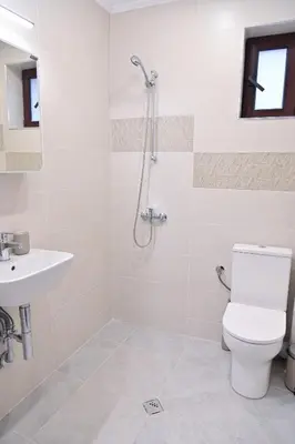 a bathroom with a shower and a toilet and a sink at White Peaks 1BR Apartment Bansko by SI Stay in Bansko