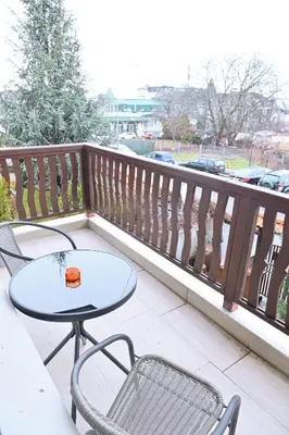 a table and two chairs on a balcony at White Peaks 1BR Apartment Bansko by SI Stay in Bansko