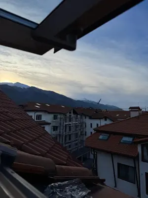a view of a city with buildings and mountains at Belmont Apartment in Bansko