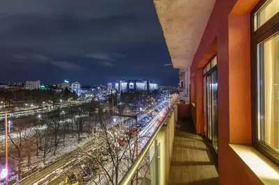 a balcony with a view of a city at night at NDK - Grand View Apartment in Sofia