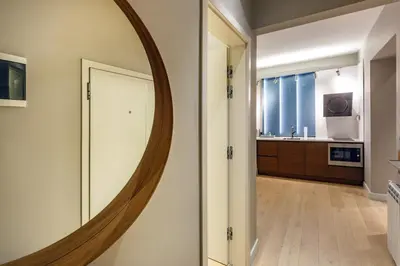 a large round mirror on the wall of a bathroom at NDK - Grand View Apartment in Sofia