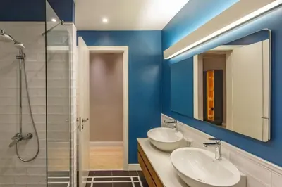 a bathroom with two sinks and a glass shower at NDK - Grand View Apartment in Sofia