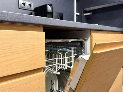 a dishwasher sitting inside of a kitchen cabinet at Near NDK - Washer&Dryer - Fast Wi-Fi - Kitchenette in Sofia