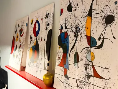 a group of paintings sitting on a shelf at Near NDK - Washer&Dryer - Fast Wi-Fi - Kitchenette in Sofia