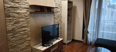 a living room with a flat screen tv on a cabinet at One Bedroom Apartment 4 - Restaurant Stadium Plovdiv in Plovdiv