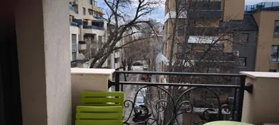 a balcony with two chairs and a view of a street at One Bedroom Apartment 2 - Restaurant Stadium Plovdiv in Plovdiv