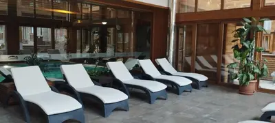a row of white chairs in a lobby at PIRIN GOLF - NIRVANA new, SPA in Razlog