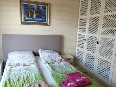 a bedroom with a bed and a picture on the wall at PIRIN GOLF - NIRVANA new, SPA in Razlog